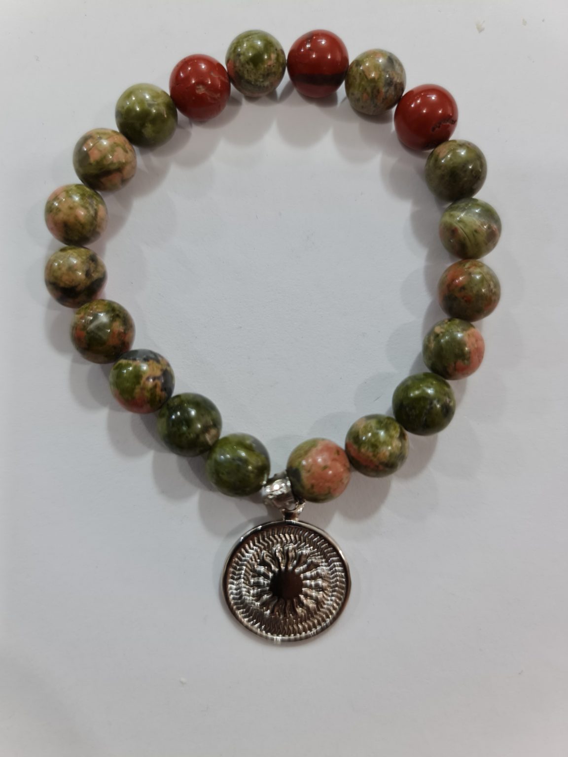 PULSERA DE CUARZO UNAKITA CON DIJE DEL ENEGRAMA SOLAR DE PLATA