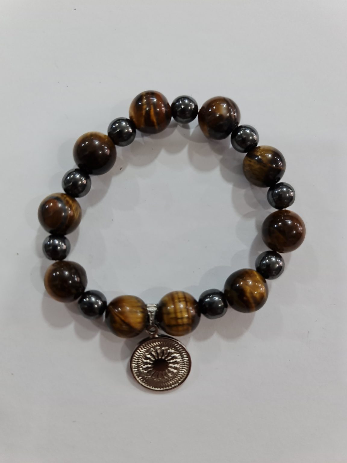 PULSERA DE CUARZO OJO DE TIGRE, CUARZO OBSIDIANA Y CUARZO ACERINA CON DIJE DEL ENEGRAMA SOLAR DE PLATA