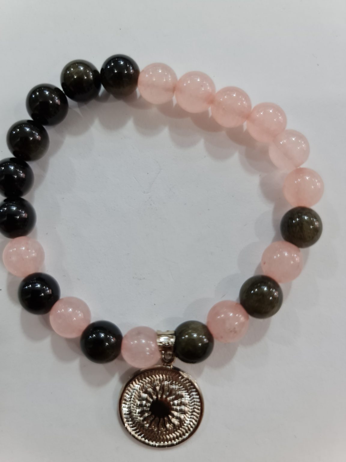 PULSERA DE CUARZO ROSA Y CUARSO OBSIDIANA CON DIJE DEL ENEGRAMA SOLAR DE PLATA