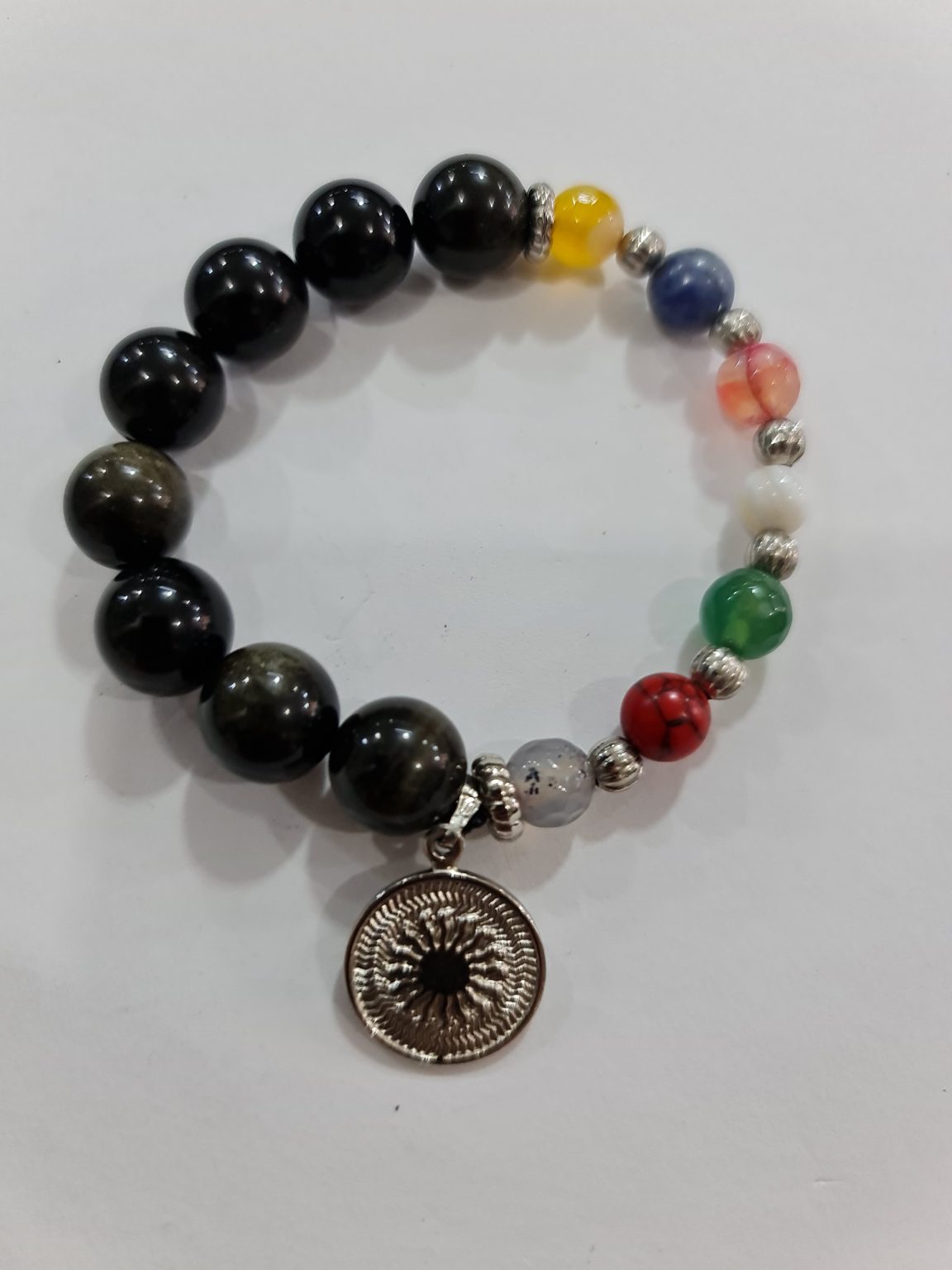 PULSERA DE CUARZO OBSIDIANA Y LOS 7 CHAKRAS CON DIJE DEL ENEGRAMA SOLAR DE PLATA