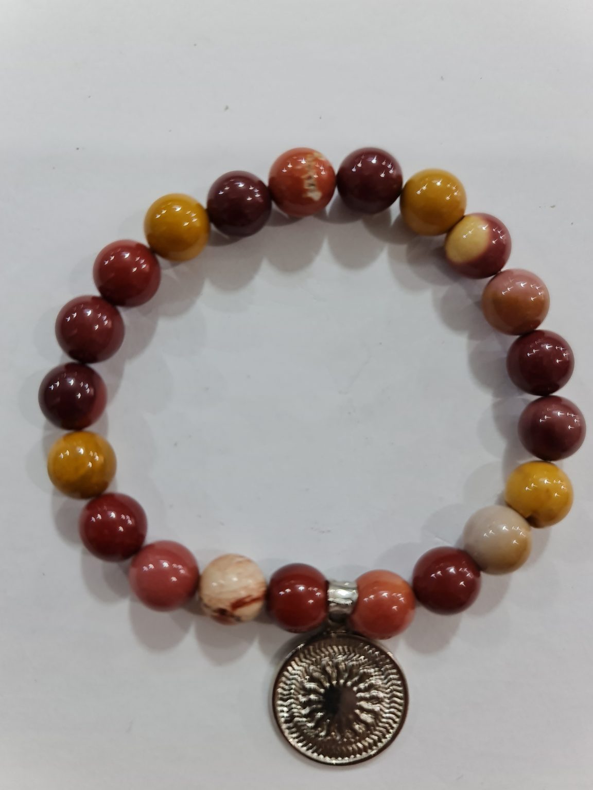 PULSERA DE CUARZO MAKAITA CON DIJE DEL ENEGRAMA SOLAR DE PLATA