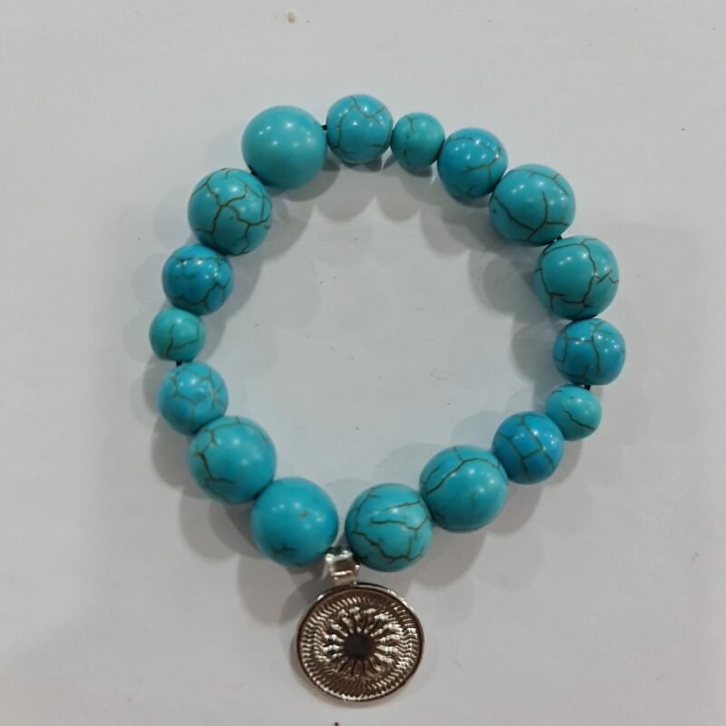 PULSERA DE CUARZO TURQUESA CON DIJE DEL ENEGRAMA SOLAR DE PLATA