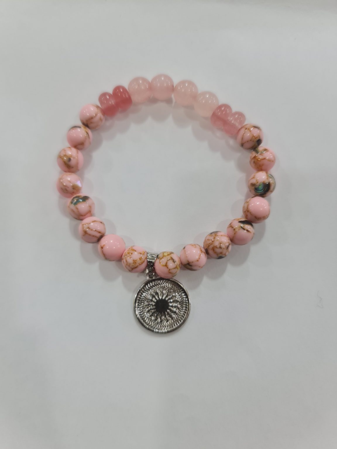 PULSERA DE CUARZO RODOCROSITA, CUARZO CHERRY Y CUARZO ROSA CON DIJE DEL ENEGRAMA SOLAR DE PLATA